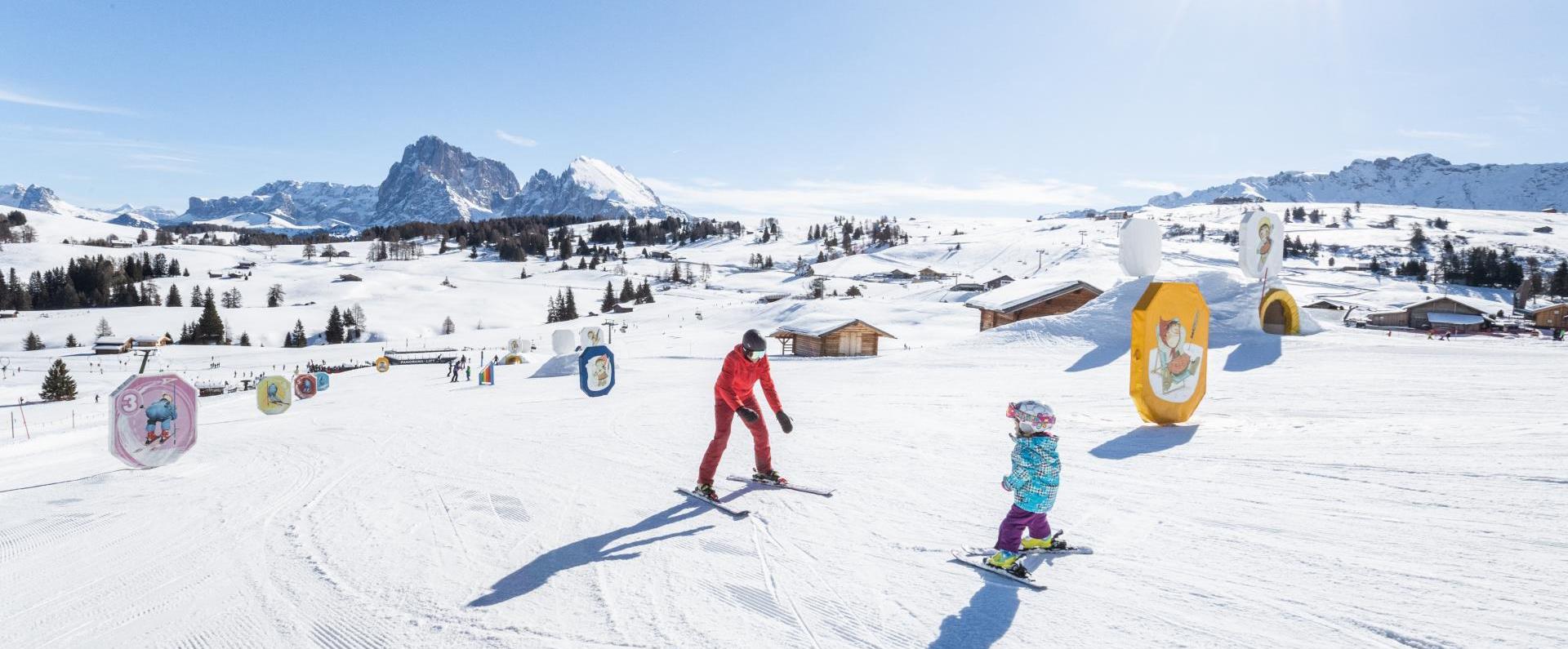 A little kid learns how to ski