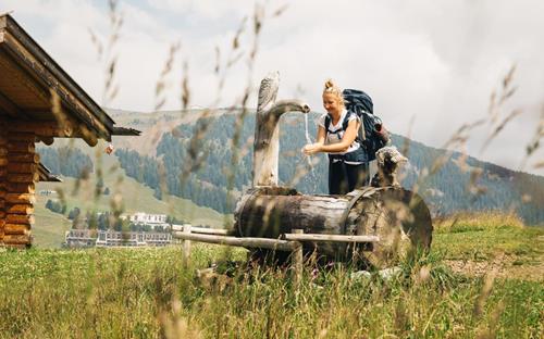 A woman at a water fountain