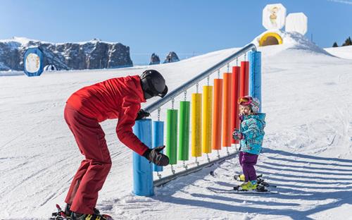 A little kid learns how to ski